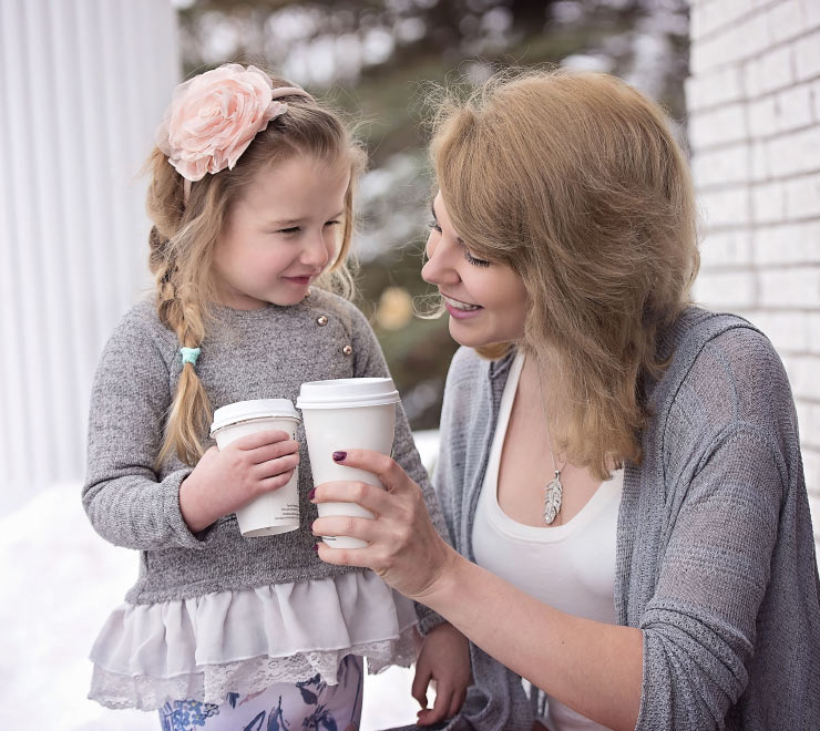 Mother and Daughter Holding Takeout Cups Mother and Daughter Holding Takeout Cups